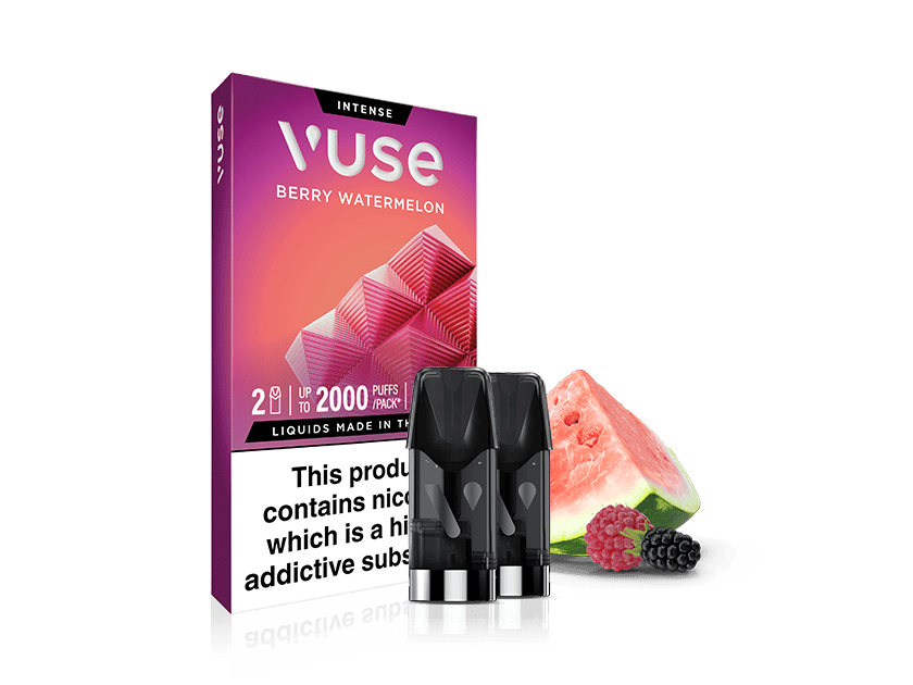 A Vuse Berry Watermelon vape pod pack with two black pods in front. The packaging is pink and purple with watermelon and berry graphics, and a watermelon slice and berries are placed beside the pods.
