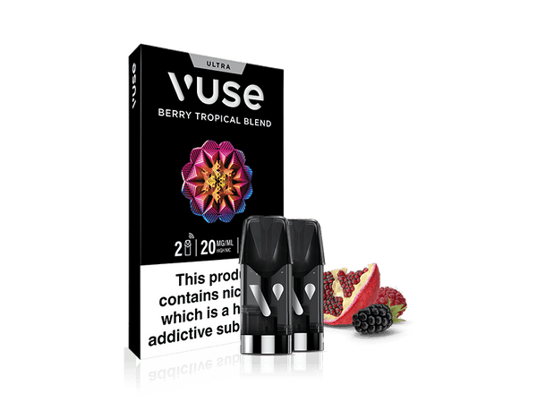 A Vuse Berry Tropical Blend vape pod pack with two pods in front. Beside them are a pomegranate half and blackberries. The packaging warns: This product contains nicotine which is a highly addictive substance.