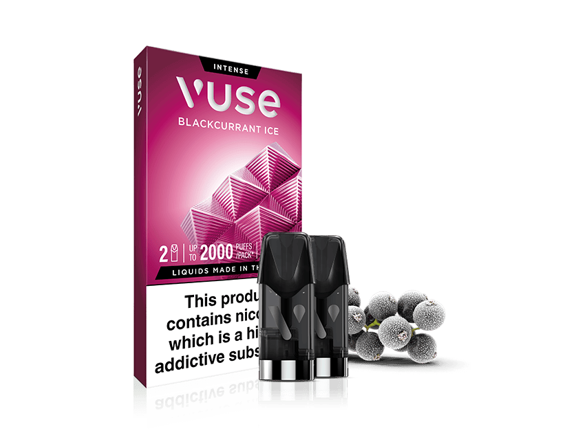 A box of Vuse Blackcurrant Ice vape pods stands upright, with three vape pods and several blackcurrants in front. The packaging features geometric patterns and a nicotine warning label.