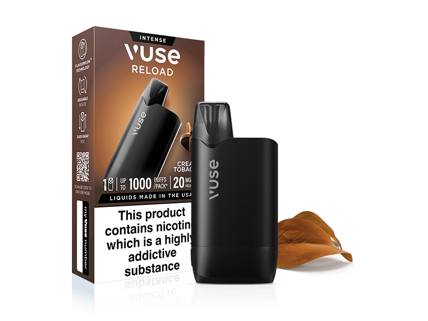 A black Vuse Reload vape device stands in front of its packaging, labeled Intense and Creamy Tobacco, with a health warning about nicotine. A couple of brown tobacco leaves are placed nearby on a white background.