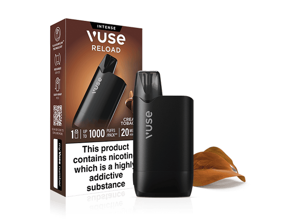 A black Vuse Reload reusable vape and its matching Creamy Tobacco Vuse Reload Box with a nicotine warning label, set against a white background with two dried leaves.