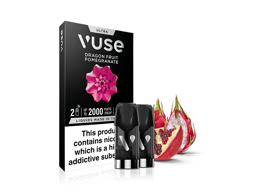 A Vuse vape cartridge pack labeled Dragon Fruit Pomegranate with three black cartridges and a sliced dragon fruit and pomegranate beside it. Warning text about nicotine is visible on the packaging.