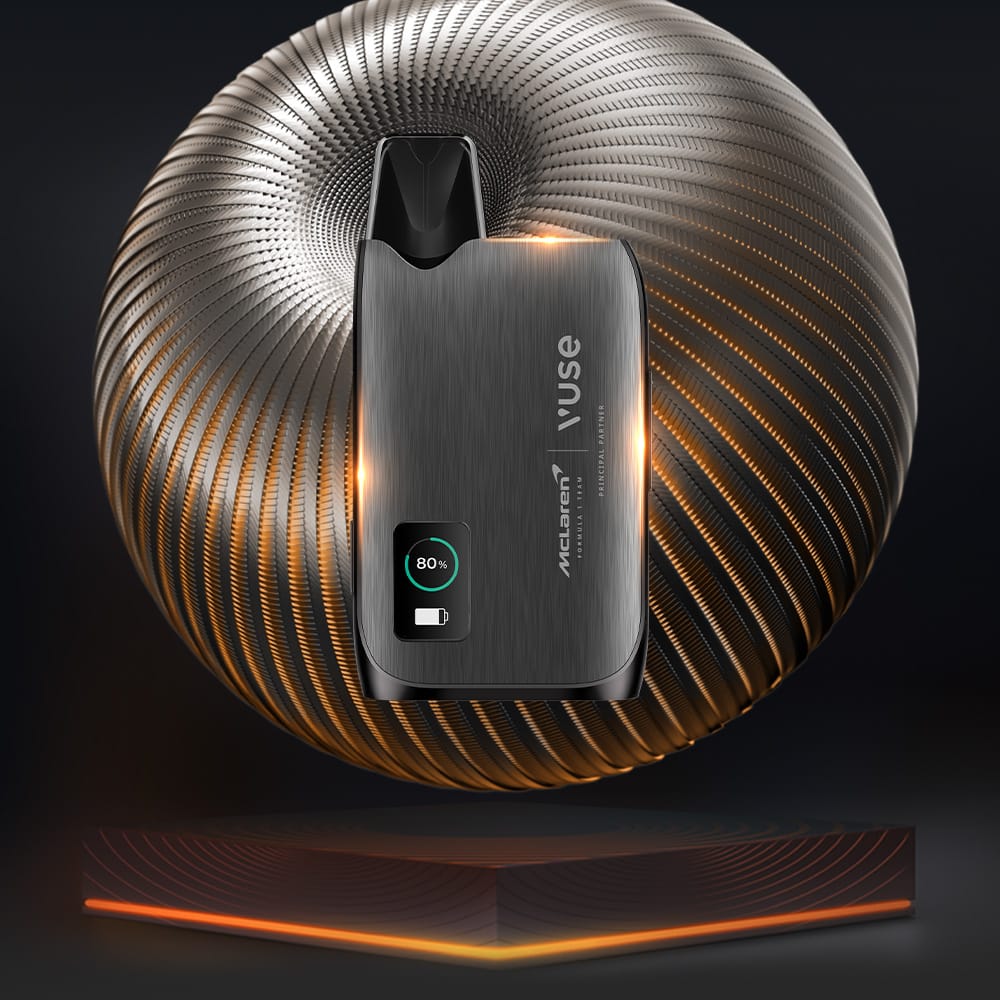 The Vuse Ultra Device McLaren stands upright before a glowing, spiral-patterned sphere, with an illuminated battery icon at 80% charge displayed at the bottom left of the metallic device.