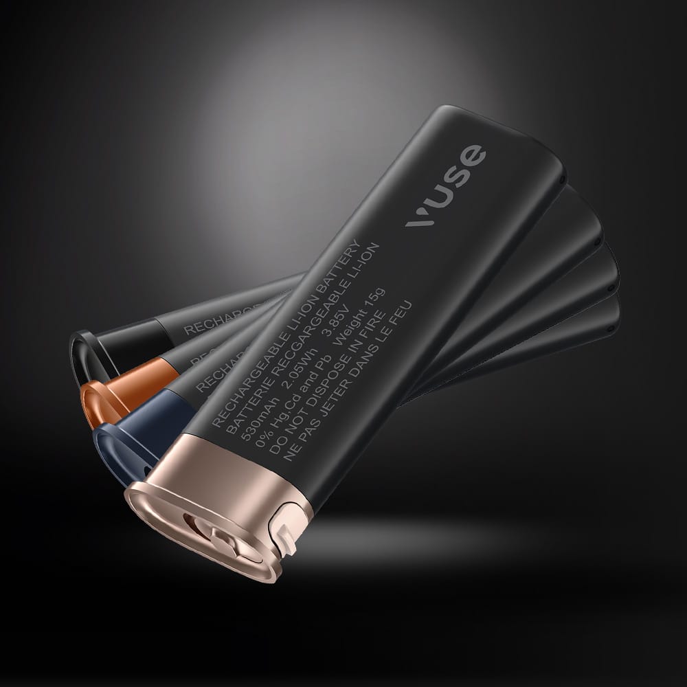 Three Vuse Ultra Replacement Batteries by Vuse, shown in black with metallic-colored ends—bronze, copper, and dark blue—fanned out against a dark background. Experience style and performance with their replaceable design.