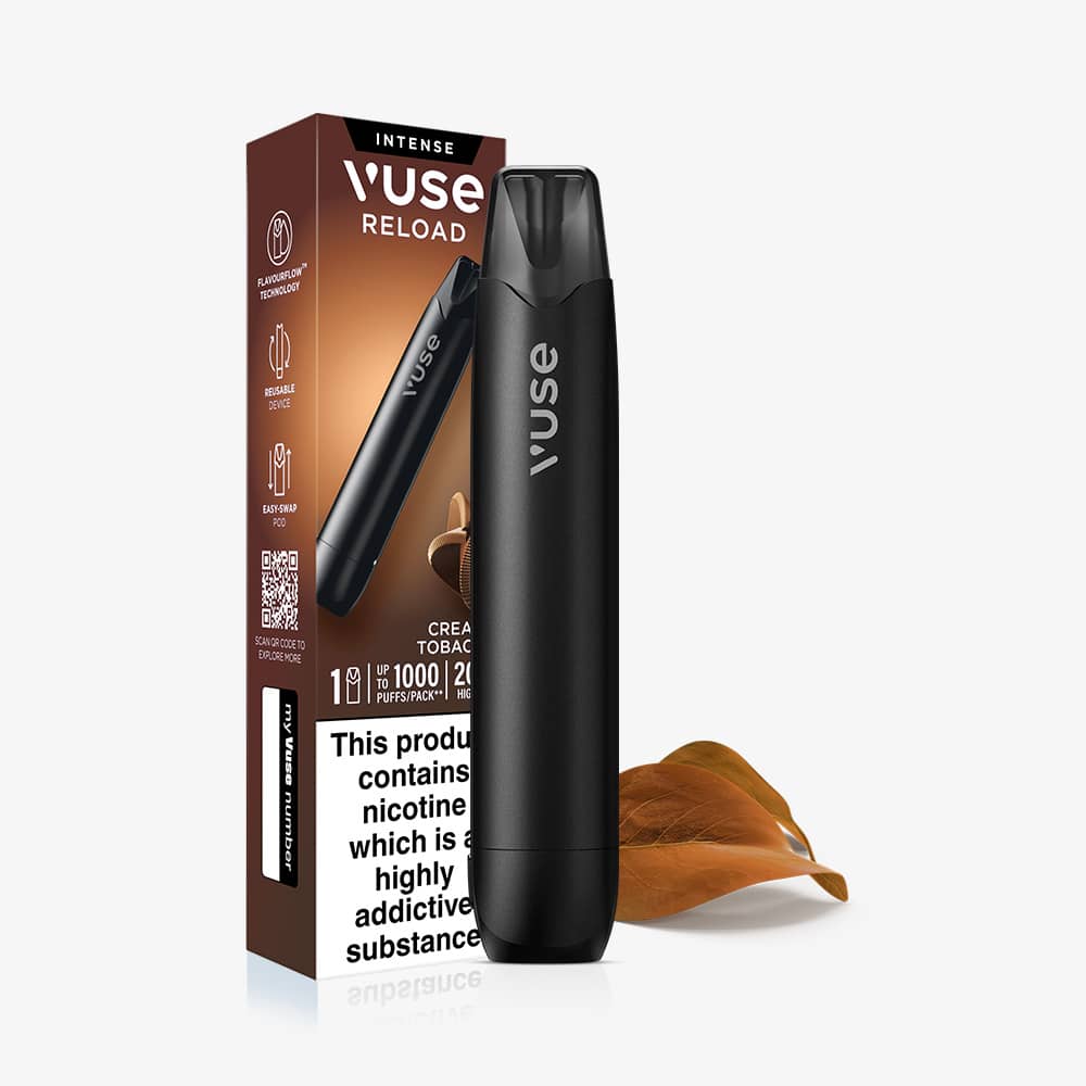 A black Creamy Tobacco Vuse Reload Pen standing next to its product packaging and a fallen leaf.