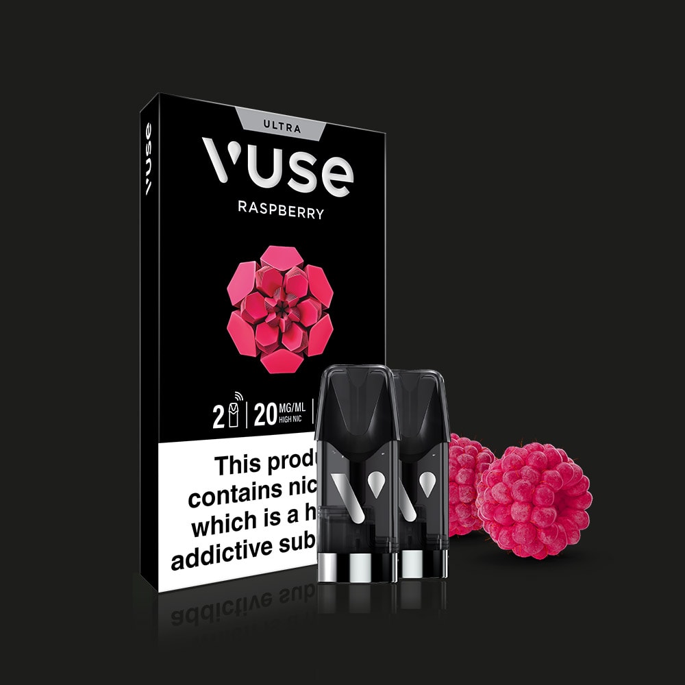 A Vuse Raspberry Ultra Smart Pod box stands upright with two pods and raspberries in front. The packaging displays a stylized raspberry, a black-background nicotine warning, and highlights ceramic heater technology.