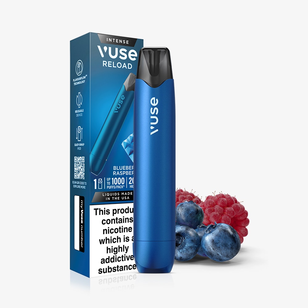 A Blueberry Raspberry Vuse Reload Pen stands before its box, which displays nicotine warnings and product details, with fresh raspberries and blueberries placed beside it.