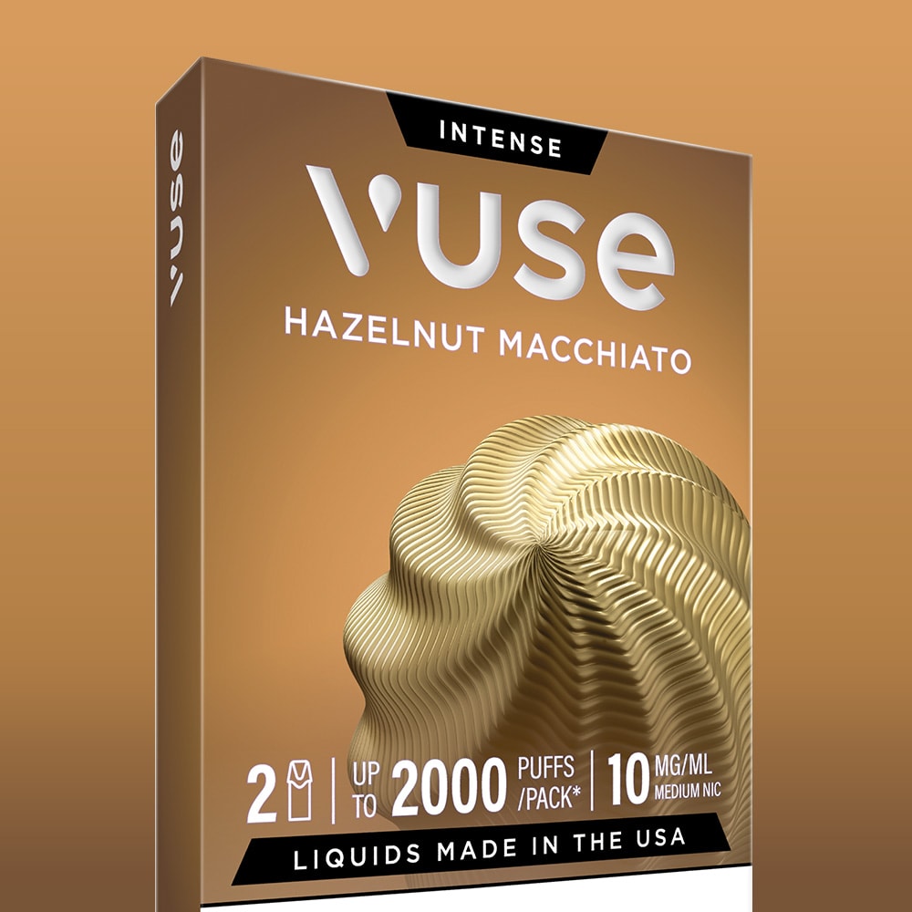 A pack of Vuse Hazelnut Macchiato Extra Intense Flavour Pods features a gold wavy design and offers up to 2000 puffs. Each box includes 2 pre-filled pods (10mg/ml nicotine). E-liquids are made in the USA.