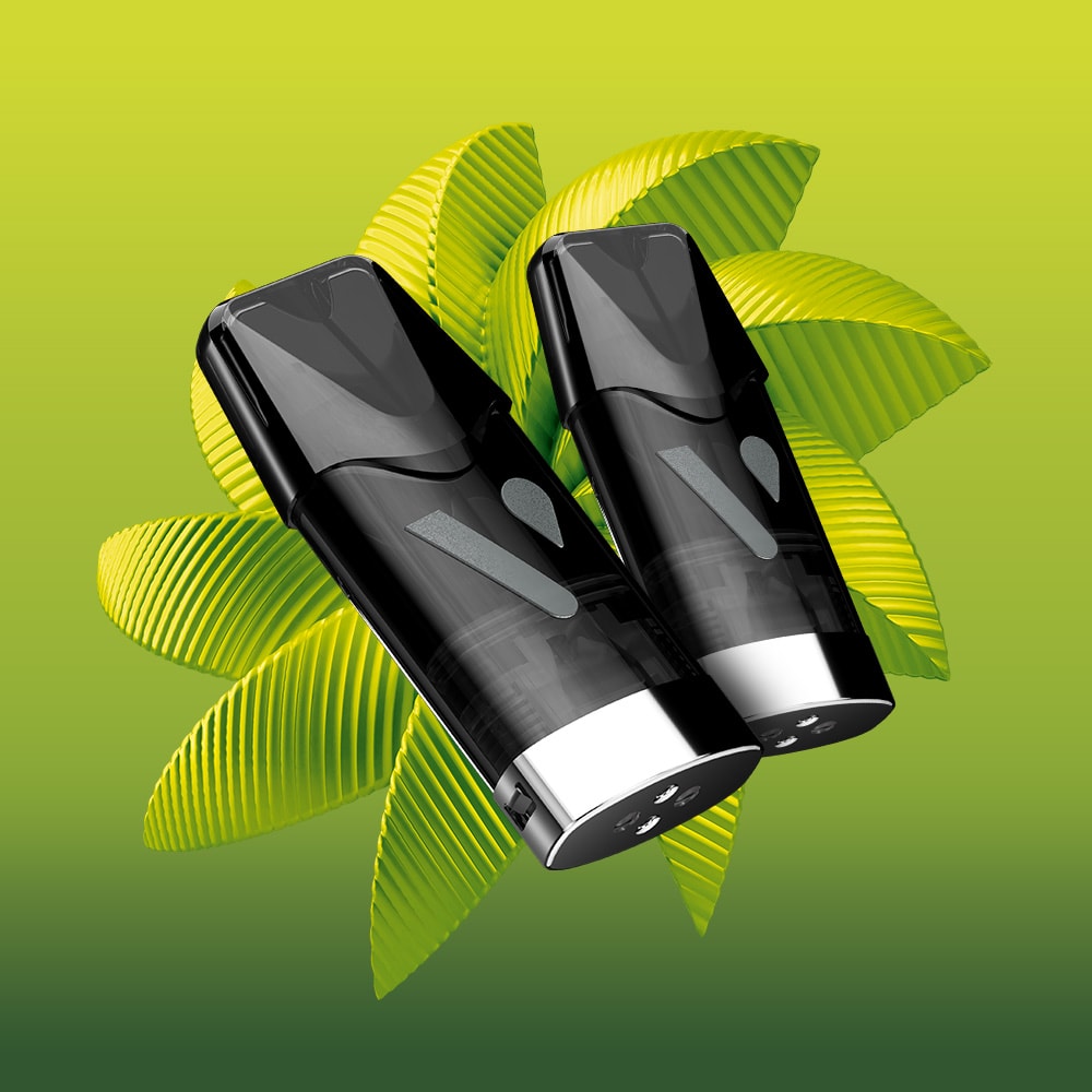 Two sleek black and silver Lemon & Lime Vuse Extra Intense Flavour Pods dispensers stand side by side before overlapping green leaves on a gradient green background, capturing the refreshing zest of Vuse’s signature flavour.