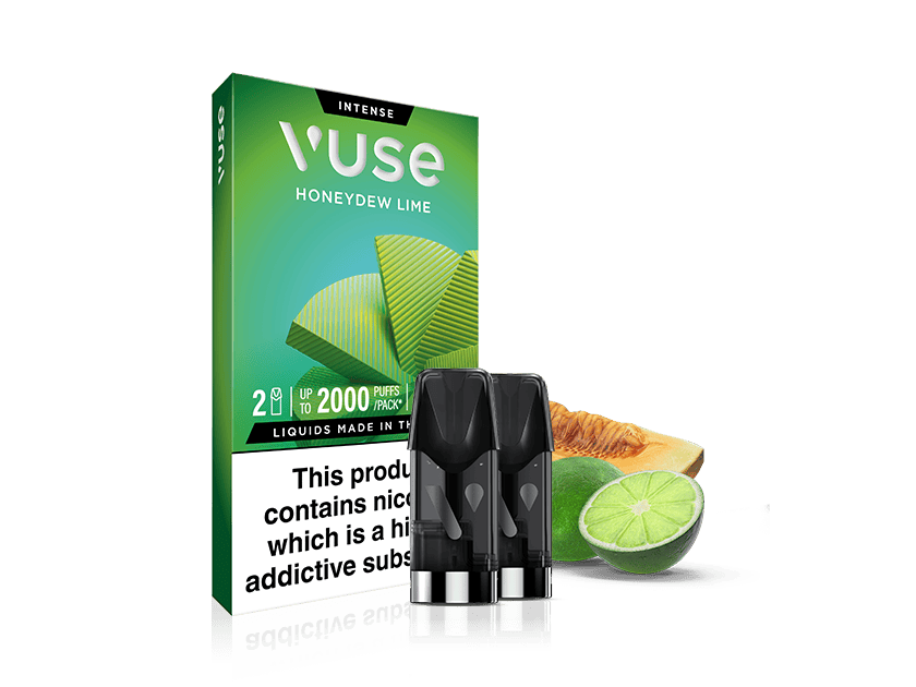 Vuse Honeydew Lime vape pod packaging with three pods in front, alongside a sliced honeydew melon and a halved lime. The box warns that the product contains nicotine, a highly addictive substance.