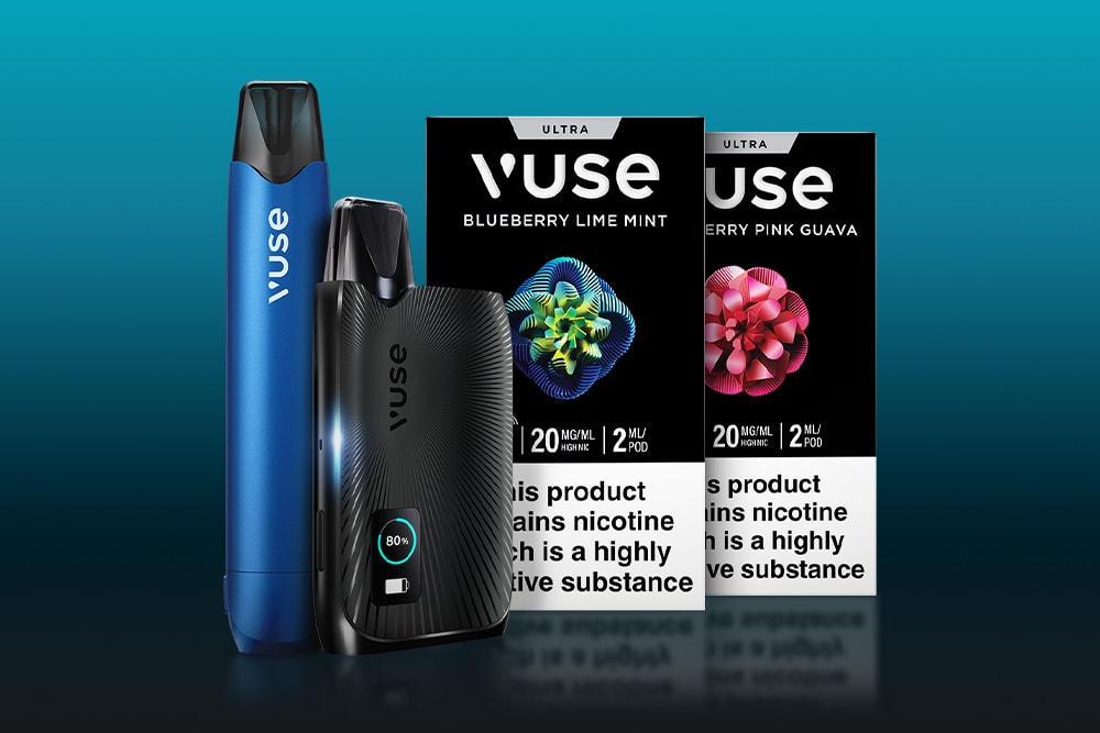 Two Vuse vape devices, one blue and one black, are displayed in front of two Vuse e-liquid packaging boxes labeled Blueberry Lime Mint and Blueberry Pink Guava with nicotine warnings on a blue gradient background.